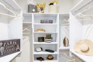 Built-in white shelves display hats, shoes and decorative boxes