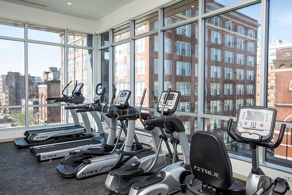 Row of elliptical machines and treadmills sit idle in the Encore fitness center