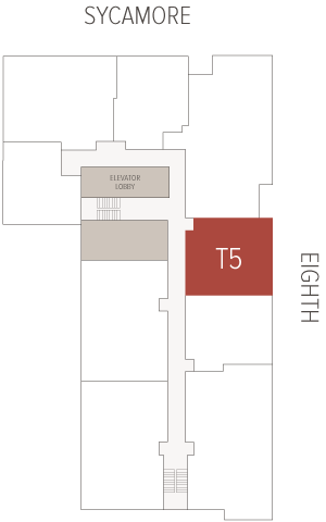 Red rectangular unit labeled T5 sits beside a central corridor and elevator lobby within a simple building floor plan showing stairwells and adjacent rooms.