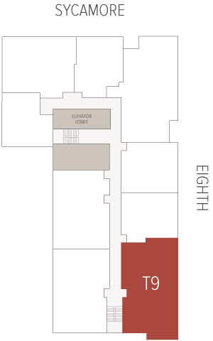 Floor plan highlighting a red T9 suite along a central corridor; elevator lobby and stairwells adjacent; surrounding building blocks outlined, oriented to Sycamore and Eighth streets.