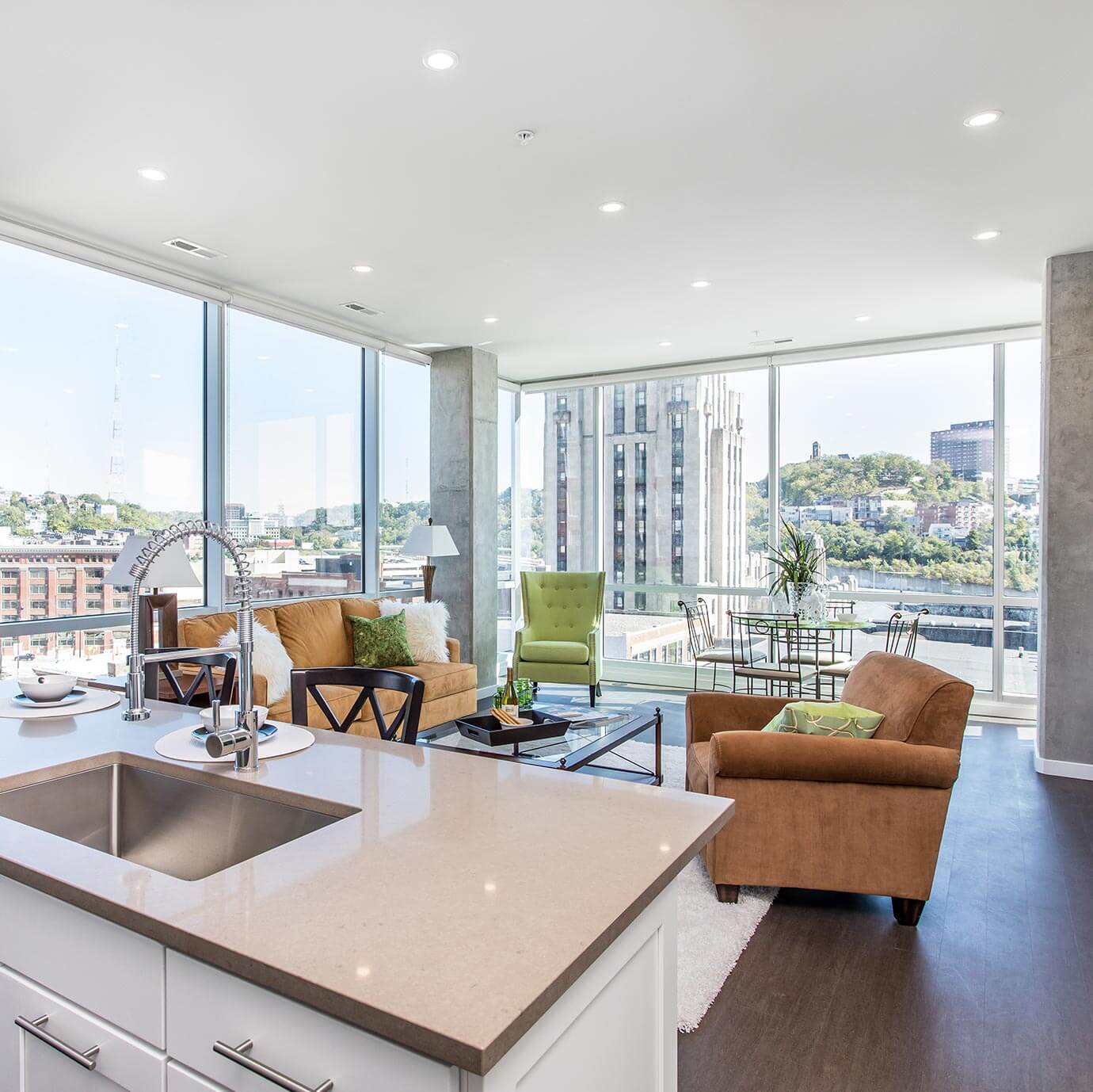 Kitchen island with sink anchors an open-plan living room